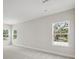 Light-filled bedroom featuring multiple windows and neutral carpeting at 4630 Cedar Fog Ct Dr, Valrico, FL 33596