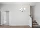View of the dining room with chandelier and access to a carpeted staircase at 4630 Cedar Fog Ct Dr, Valrico, FL 33596