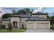 Stunning two-story home featuring a neutral palette, well-manicured landscaping, a gray roof, and a two-car garage at 4630 Cedar Fog Ct Dr, Valrico, FL 33596