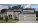 Elegant two-story home featuring a three-car garage, paved driveway, and beautifully landscaped front yard at 4630 Cedar Fog Ct Dr, Valrico, FL 33596