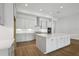 Bright kitchen featuring white cabinets, stainless steel appliances, and a center island at 4630 Cedar Fog Ct Dr, Valrico, FL 33596