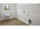 Functional laundry room features wood flooring and a utility sink at 4630 Cedar Fog Ct Dr, Valrico, FL 33596
