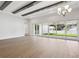Bright living room with ceiling beams and large sliding glass doors at 4630 Cedar Fog Ct Dr, Valrico, FL 33596