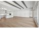 Vast living room with wood floors extending into a stylish white kitchen area at 4630 Cedar Fog Ct Dr, Valrico, FL 33596