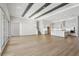 Open-concept living room with wood floors connecting to a modern white kitchen at 4630 Cedar Fog Ct Dr, Valrico, FL 33596