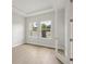 A room with light wood floors and two windows that stream in natural light at 4630 Cedar Fog Ct Dr, Valrico, FL 33596
