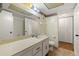Bright bathroom with a large mirror, white cabinets and a toilet at 4908 38Th S Way # 206, St Petersburg, FL 33711