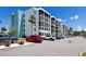 Spacious condo building featuring multiple units, parking, and palm trees in a sunny, desirable location at 4908 38Th S Way # 206, St Petersburg, FL 33711