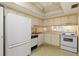 Efficient kitchen features white appliances, ample cabinet space, and neutral countertops for a clean and bright space at 4908 38Th S Way # 206, St Petersburg, FL 33711