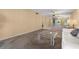 Spacious living room features neutral decor, carpeted floors, and sliding glass doors to a balcony with mirrored wall at 4908 38Th S Way # 206, St Petersburg, FL 33711