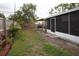 Spacious backyard featuring a wooden fence, patio area, and lush greenery, perfect for outdoor living and entertaining at 5205 98Th N Ter, Pinellas Park, FL 33782