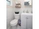 Stylish half-bathroom featuring modern fixtures, a pristine vanity, and decorative shelving for a fresh look at 5205 98Th N Ter, Pinellas Park, FL 33782