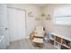 Charming Bedroom with cozy rocking chair, storage shelves, and ample closet space, perfect for a growing Gathering at 5205 98Th N Ter, Pinellas Park, FL 33782