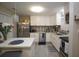 Modern kitchen with white cabinets, stainless steel appliances, and chic backsplash, ideal for culinary enthusiasts at 5205 98Th N Ter, Pinellas Park, FL 33782