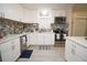 Bright kitchen with white cabinets, stainless appliances, and mosaic backsplash, blending style and functionality at 5205 98Th N Ter, Pinellas Park, FL 33782