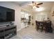 Open-concept living and dining area with modern light fixtures, new flooring and sleek, neutral decor at 5205 98Th N Ter, Pinellas Park, FL 33782