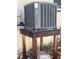 This AC unit is elevated for protection and efficient cooling in a compact outdoor space at 5445 Manatee Point Dr, New Port Richey, FL 34652