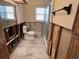 This bathroom offers a partially renovated space, with a toilet, mirror, and fixtures ready for your final touches at 5445 Manatee Point Dr, New Port Richey, FL 34652