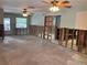 Spacious living room ready for renovation, featuring exposed framework and ample space for personalization at 5445 Manatee Point Dr, New Port Richey, FL 34652