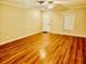 Spacious living room featuring hardwood floors, a ceiling fan and a large window at 5722 Fishhawk Ridge Dr, Lithia, FL 33547