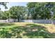 Large fenced backyard with green grass, a shed for storage, and mature shade trees at 606 Brentwood Pl, Brandon, FL 33511