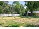 Backyard featuring a lawn, partial fence, scattered trees, and an antenna for amateur radio at 606 Brentwood Pl, Brandon, FL 33511