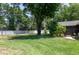 Expansive backyard with lush green lawn, privacy fence, and tropical landscaping near the house at 606 Brentwood Pl, Brandon, FL 33511