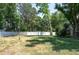 Spacious backyard featuring a well-maintained lawn, white fencing, and mature trees at 606 Brentwood Pl, Brandon, FL 33511