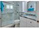 Beautiful bathroom with blue accents, a glass enclosed shower, and a modern vanity with granite countertop at 606 Brentwood Pl, Brandon, FL 33511