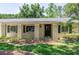 Charming entrance with dark door, updated landscaping, and shuttered windows at 606 Brentwood Pl, Brandon, FL 33511