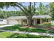 Landscaped front yard with mature shade tree provides a beautiful setting for this home at 606 Brentwood Pl, Brandon, FL 33511