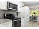 Well-equipped kitchen featuring granite countertops, white cabinets, and stainless steel oven range at 606 Brentwood Pl, Brandon, FL 33511