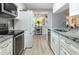 Modern kitchen features stainless steel appliances, granite countertops, and sleek white cabinetry at 606 Brentwood Pl, Brandon, FL 33511