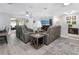 Spacious living area with modern furniture, opening to a tiled sun room at 606 Brentwood Pl, Brandon, FL 33511