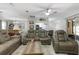 Open-concept living room boasts comfortable seating, modern decor, and seamless flow to the kitchen at 606 Brentwood Pl, Brandon, FL 33511