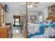 Spacious main bedroom features a four-poster bed, tile floors, and access to the screened porch at 606 Brentwood Pl, Brandon, FL 33511