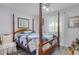 Bedroom boasts a four-poster bed, wood-look floors, and a bright airy atmosphere with large windows at 606 Brentwood Pl, Brandon, FL 33511