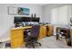 Home office featuring a large desk, multiple monitors, shelving units, and a comfortable office chair at 606 Brentwood Pl, Brandon, FL 33511