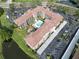Aerial view of building with a community pool and well-manicured lawn at 6150 Gulfport S Blvd # 302, Gulfport, FL 33707