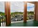 Balcony view overlooking the parking area with lush landscaping and clear skies at 6150 Gulfport S Blvd # 302, Gulfport, FL 33707