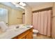 Well-lit bathroom featuring classic fixtures, vanity, and a shower with a patterned curtain at 6150 Gulfport S Blvd # 302, Gulfport, FL 33707