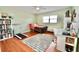 Bright bedroom with hardwood floors, a ceiling fan, and a large window at 6150 Gulfport S Blvd # 302, Gulfport, FL 33707