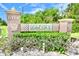 Elegant community sign amidst well-maintained landscaping and lush greenery at 6150 Gulfport S Blvd # 302, Gulfport, FL 33707