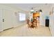 Inviting dining room adjacent to kitchen with tile flooring, modern decor, and natural light at 6150 Gulfport S Blvd # 302, Gulfport, FL 33707