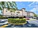 Exterior view of the condos with covered parking and decorative green landscaping at 6150 Gulfport S Blvd # 302, Gulfport, FL 33707