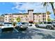 Well-maintained building exterior with ample parking and mature palm trees at 6150 Gulfport S Blvd # 302, Gulfport, FL 33707