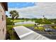 Scenic golf course view with lush green, serene lake, mature palms, and convenient parking at 6150 Gulfport S Blvd # 302, Gulfport, FL 33707