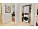 Cozy laundry closet featuring a stacked washer and dryer and adjacent to living space at 6150 Gulfport S Blvd # 302, Gulfport, FL 33707