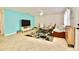 Bright living room featuring tile floors, modern furniture, television, and a floral area rug at 6150 Gulfport S Blvd # 302, Gulfport, FL 33707