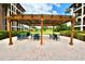 Outdoor patio area with pergola, seating, and views of the manicured lawn at 6150 Gulfport S Blvd # 302, Gulfport, FL 33707